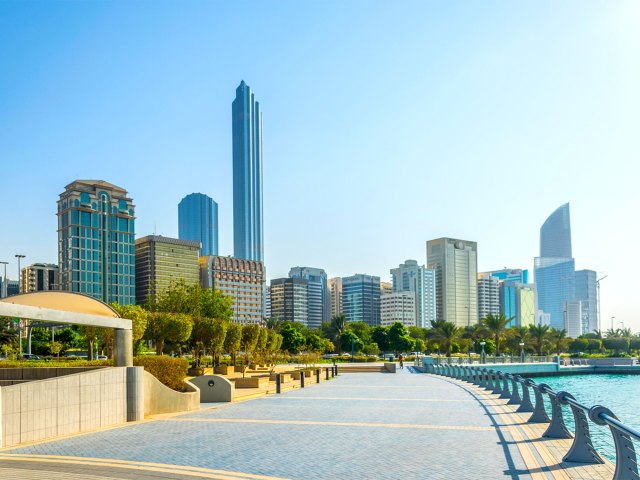 Pathway along river with Abu Dhabi skyline