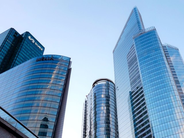 View up at glass skyscrapers in Paris, seen from street level