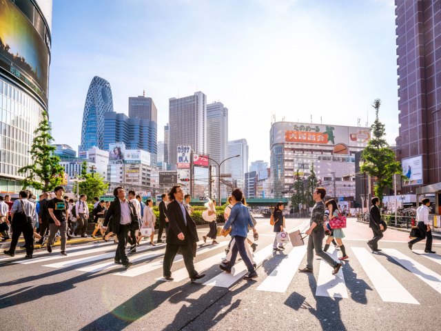 Pedestrians crossing street in downtown Tokyo, Japan