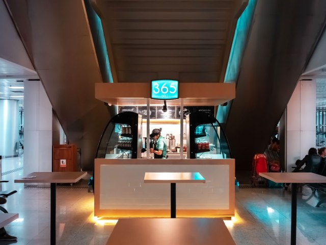 Person working at coffee shop inside airport terminal