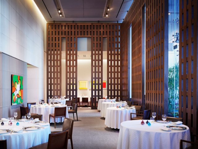 Tables covered in white tablecloths in Restaurant, Guy Savoy in Las Vegas, Nevada