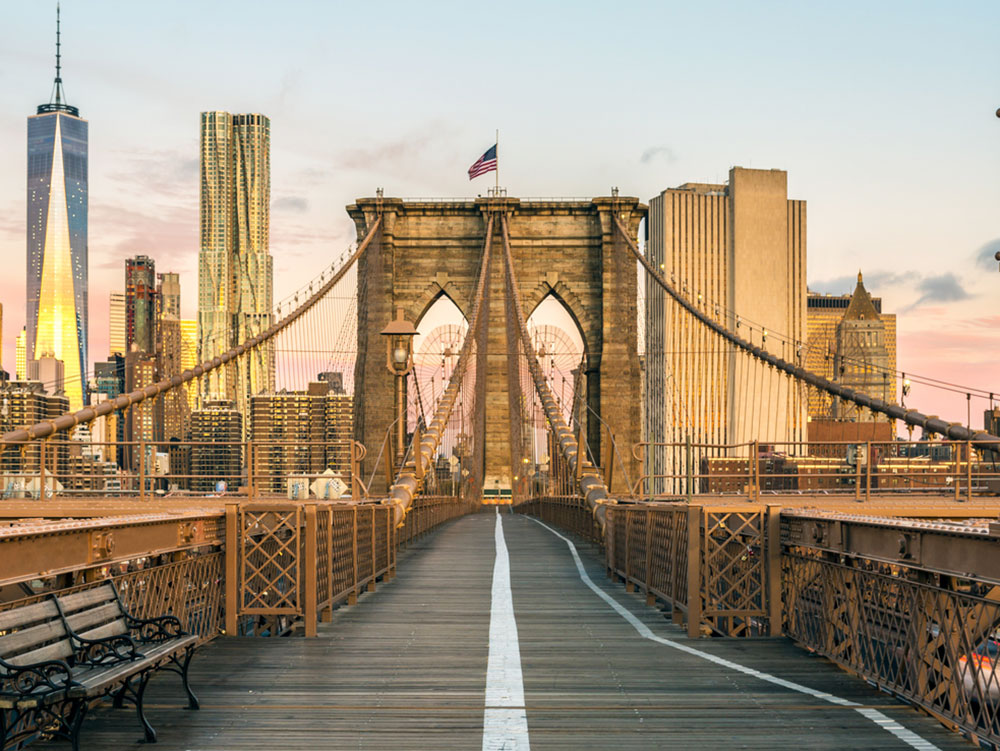 Brooklyn bridge empty and leading up to the New York City skyline 