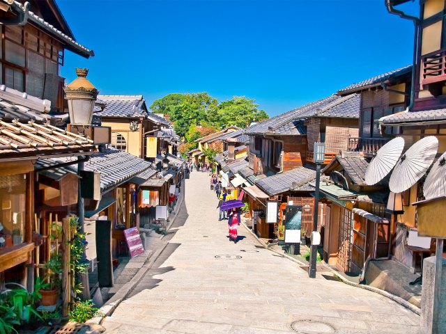 Tourists walking among traditional architecture of Kyoto, Japan