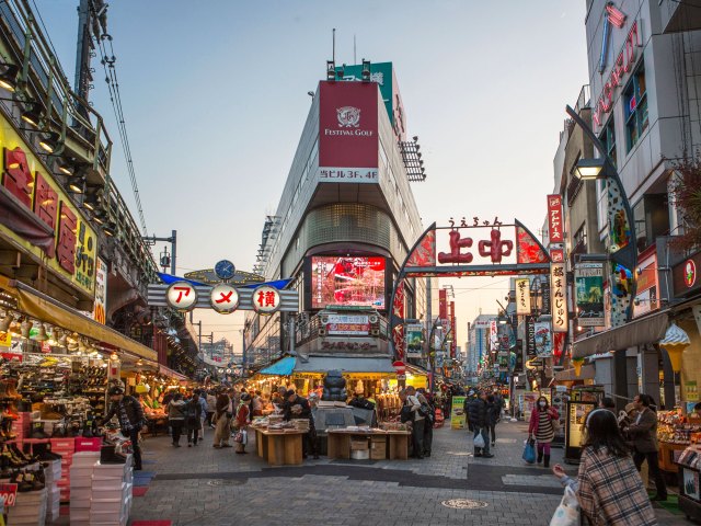 People walking through Ameyoko Market in Tokyo, Japan, at dusk