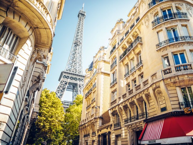 View of Eiffel Tower between buildings of Paris, France