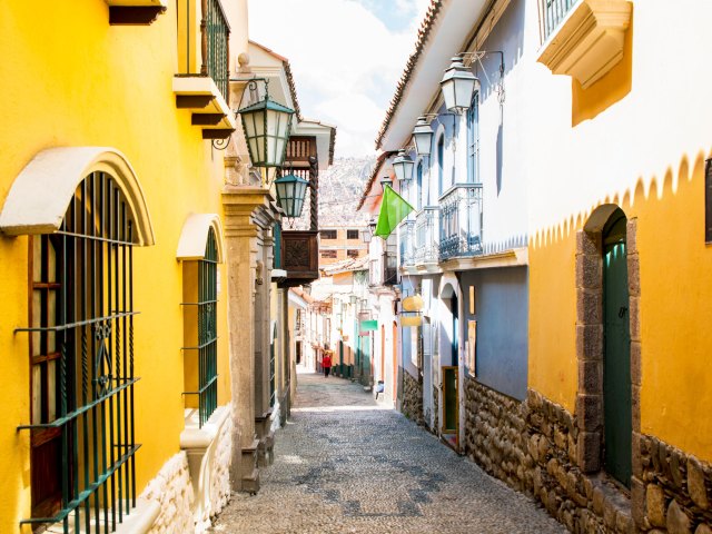 Brightly painted homes flanking narrow alleyway in La Paz, Bolivia