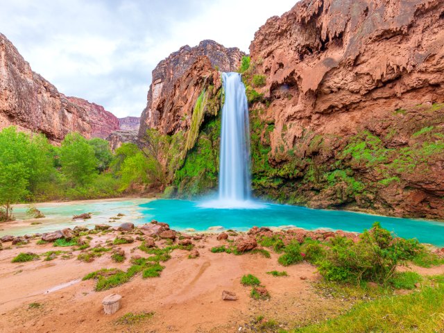 View of Havasu Falls amid red sandstone of Arizona desert