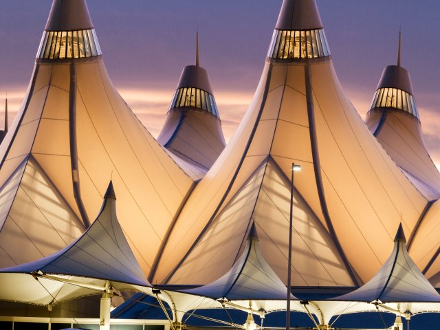 Close-up of fabric-covered tents topping terminal at Denver International Airport, seen during dusk