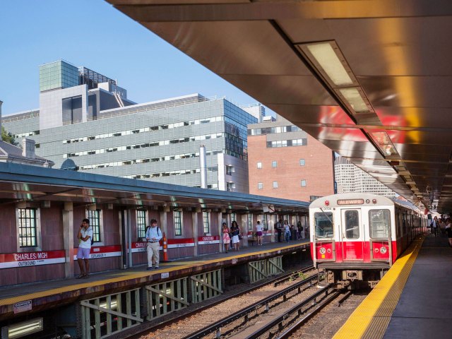 Train pulling into Boston "T" station as commuters wait on platform