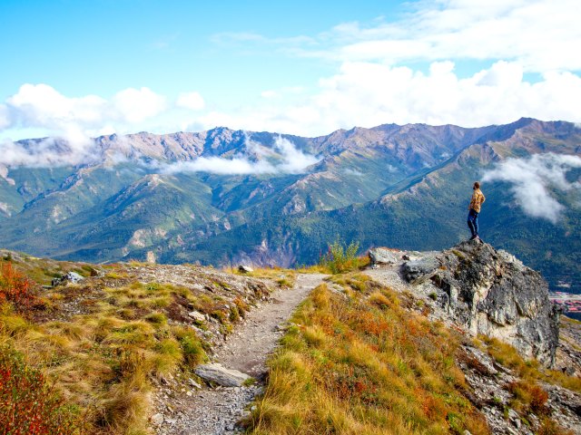 Hiker standing on boulder overlooking Denali National Park in Alaska