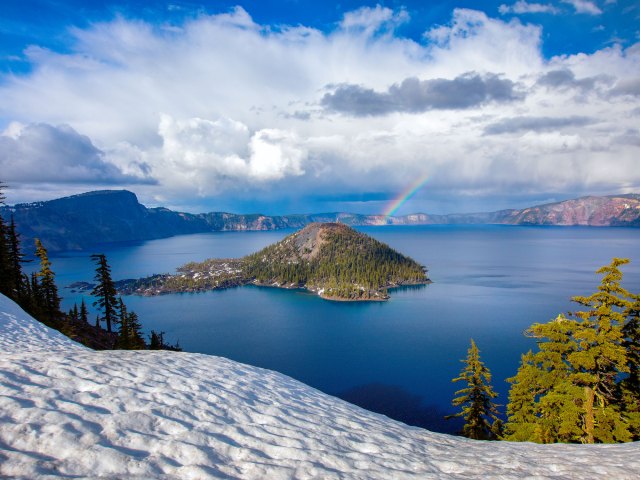 Rainbow forming over Wizard Island in Oregon, seen from above