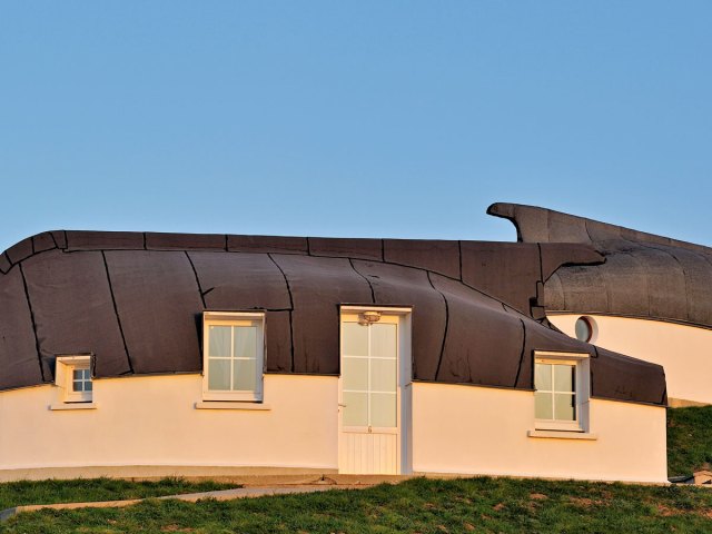 Modern-day camping site of upturned boat houses in Équihen-Plage, France