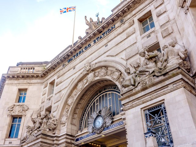 Statues and clock adorning exterior of London Waterloo Station