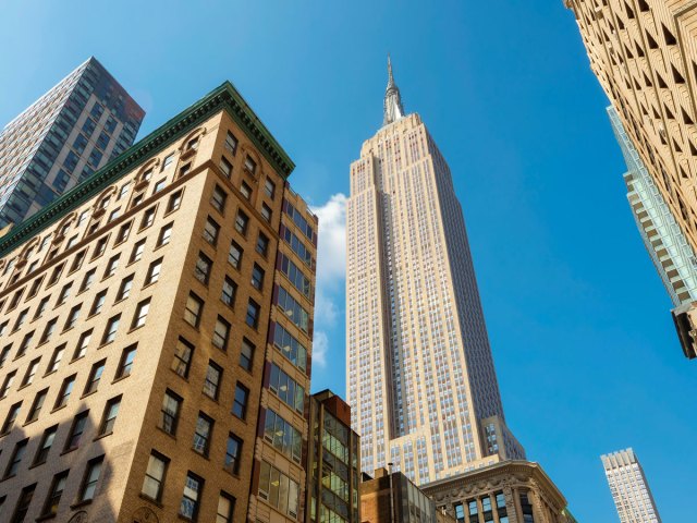 View up at Empire State Building in New York City from street level