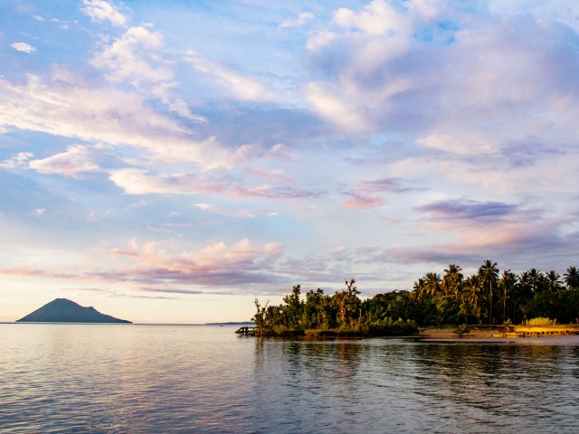 Palm tree-covered island in Bunaken Marine National Park in Indonesia