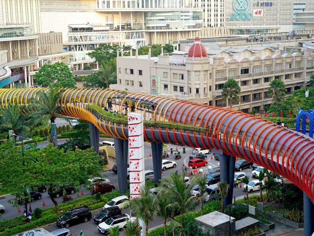 Aerial view of pedestrian bridge over busy street in Jakarta, Indonesia