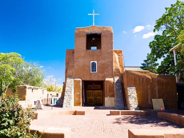 Courtyard and adobe facade of the San Miguel Mission in Santa Fe, New Mexico