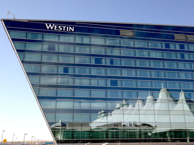 Terminal building reflected on Westin Hotel at Denver International Airport