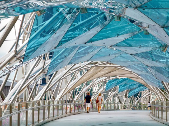 Couple walking on the Helix bridge in Singapore