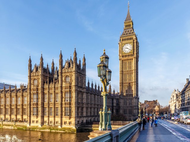 Big Ben clock tower along Thames River in London, England