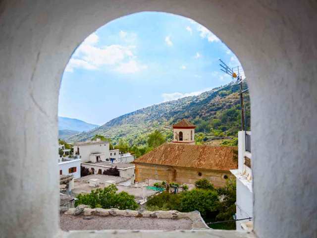 View of church through stone archway in Spain