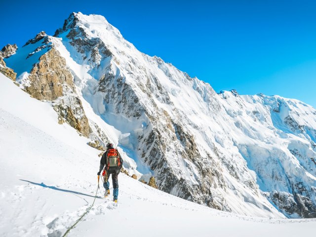 Mountain climber on snowy peak