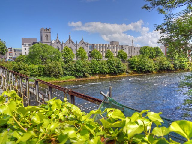 Bridge overlooking river and church in Galway, Ireland