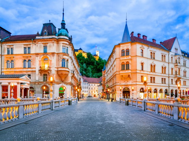 Bridge in Ljubljana, Slovenia, with view of hilltop castle in the distance