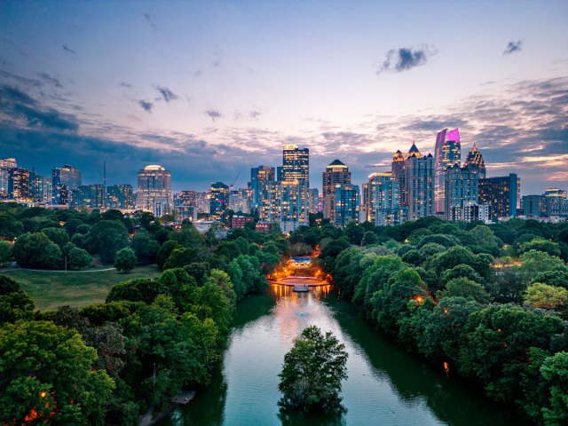 Aerial view of city park in Atlanta, Georgia, and skyscrapers in distance, lit at night