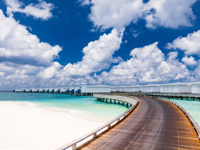 Pier leading to overwater bungalows in the Maldives