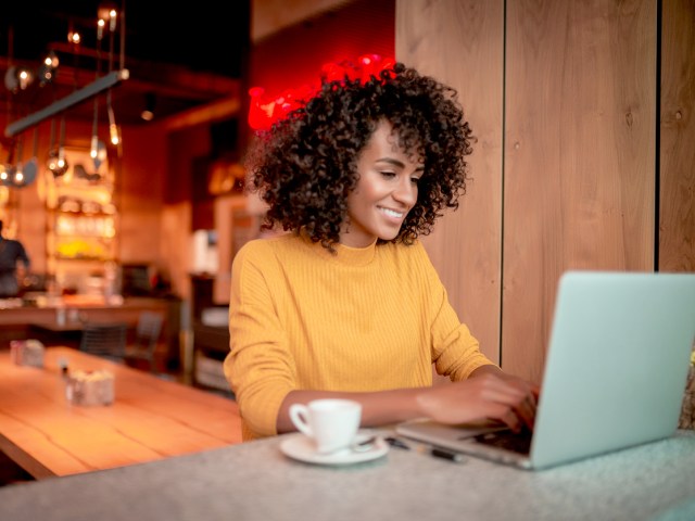 Women at cafe with laptop and coffee