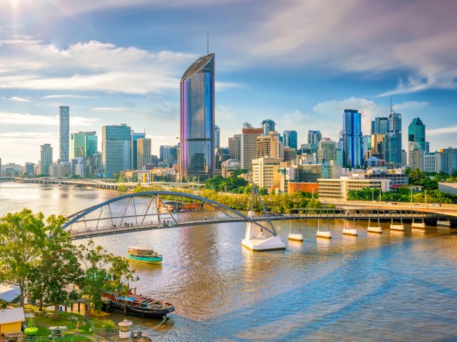 Aerial view of bridge over river and skyscrapers of Brisbane, Australia