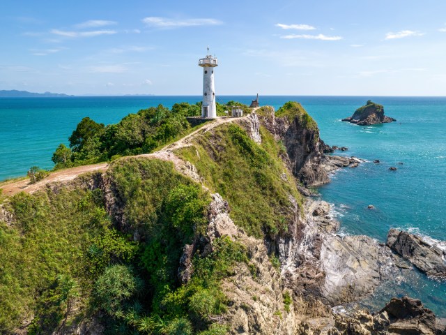 Lighthouse on rocky peninsula of Koh Phayam in Thailand