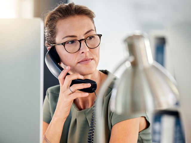 Woman at desk on a telephone call