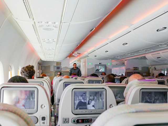 View from airplane seat looking toward front of cabin