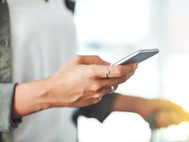 Zoomed-in image of traveler holding cell phone