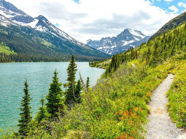 Hiking trail beside lake and mountains in national park