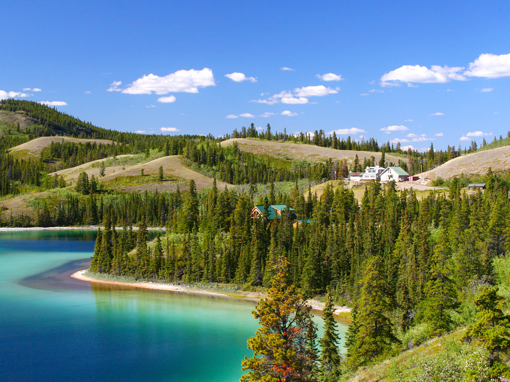 Aerial view of Alaska lake surrounded by hillside homes in summer