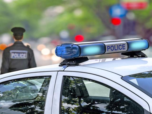 Police officer walking away from patrol car