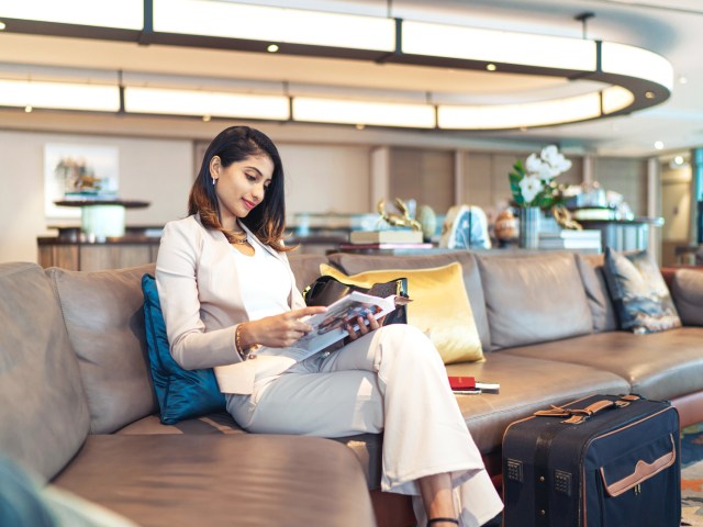 Passenger reading in airport lounge