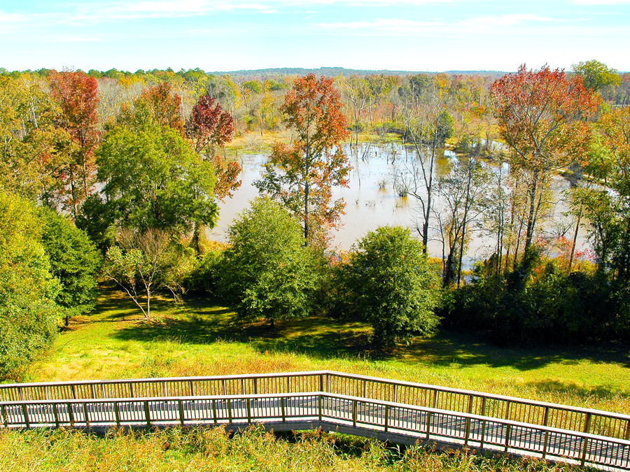 Wooden pathway leading to lake at Ocmulgee Mounds National Historical Park in Georgia