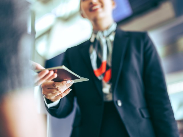 Airport agent checking passenger's passport