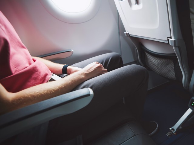 Close-up of passenger seated in airplane seat