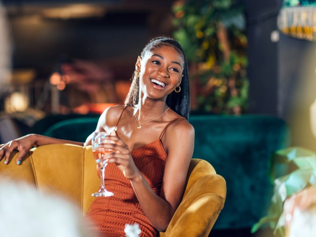 Hotel guest enjoying glass of wine in lounge