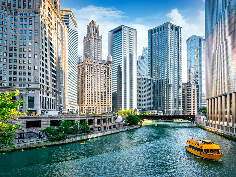 Boat cruising between skyscrapers on the Chicago River