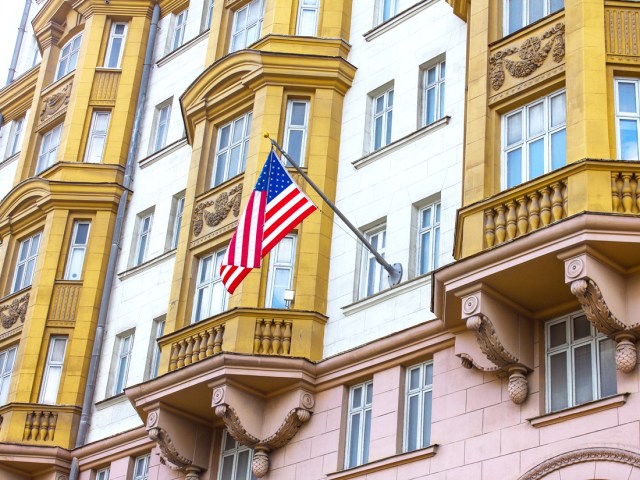 American flag flying outside of embassy building