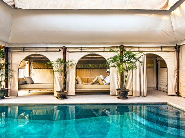 Hotel guest lounging in pool cabana