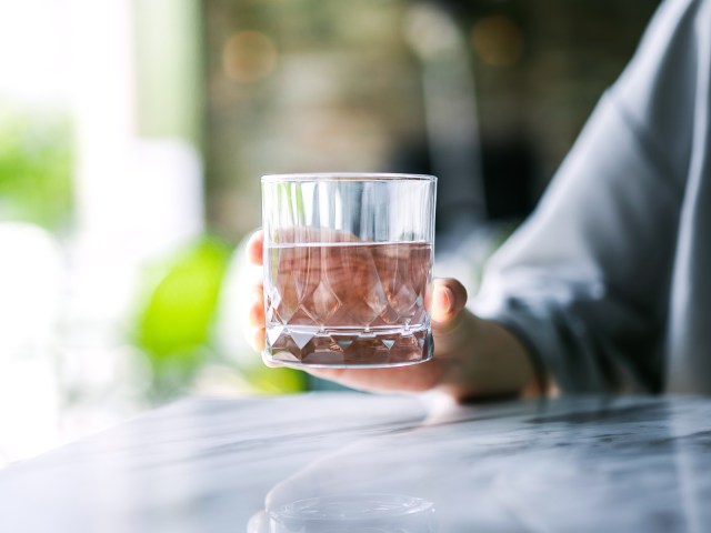 Person holding cocktail glass