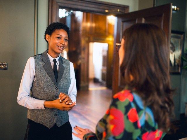 Hotel guest interacting with staff member