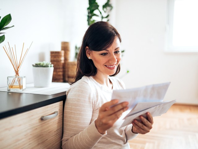 Person sorting through mail at home